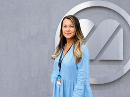 A woman with a stethoscope standing in front of a wall.