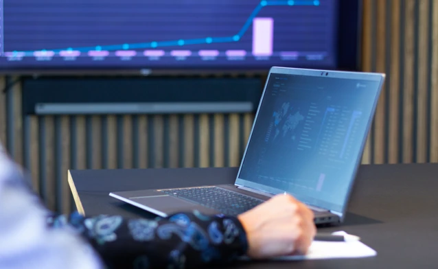 laptop on a table showing Monitor ERP Dashboard