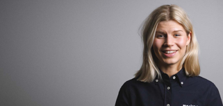 A woman in a black shirt is smiling.