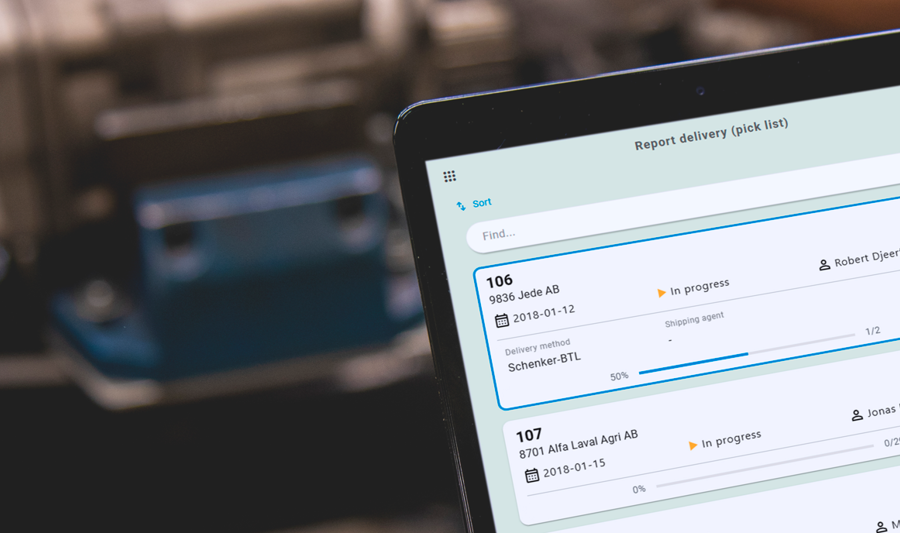 A person holding a tablet computer in a factory.