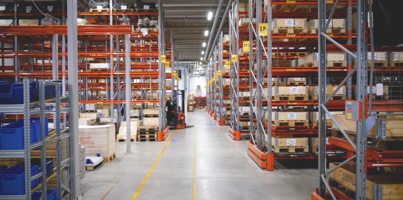 A large warehouse filled with lots of shelves.