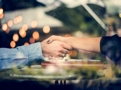 A close up of two people shaking hands.
