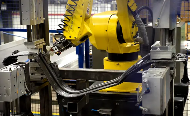 A robot is working on a piece of machinery.