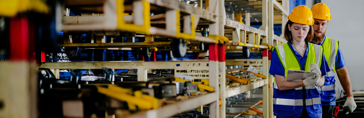 workers checking and inspecting metal machine part items for shipping. male and woman checking the store factory. industry factory warehouse. The warehouse of spare part for machinery and vehicles.