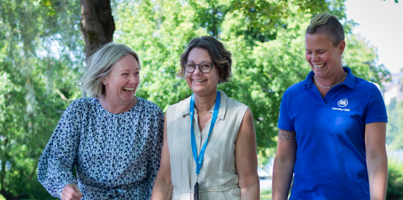Three employees at Monitor taking a walk outside.