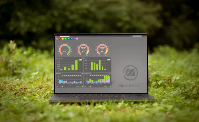 Illustration of Monitor ERP dashboards on a screen placed in nature, symbolizing sustainability.
