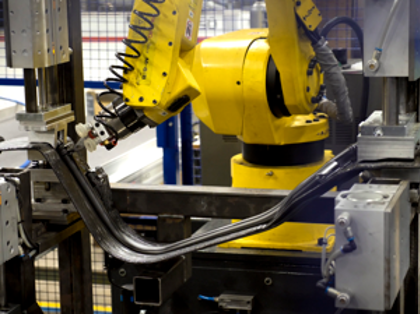 A robot working on a piece of machinery.