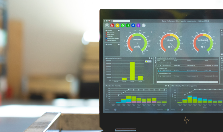 Monitor ERP dashboard displayed on a laptop in a factory environment