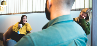 A man and a woman sitting on a couch.
