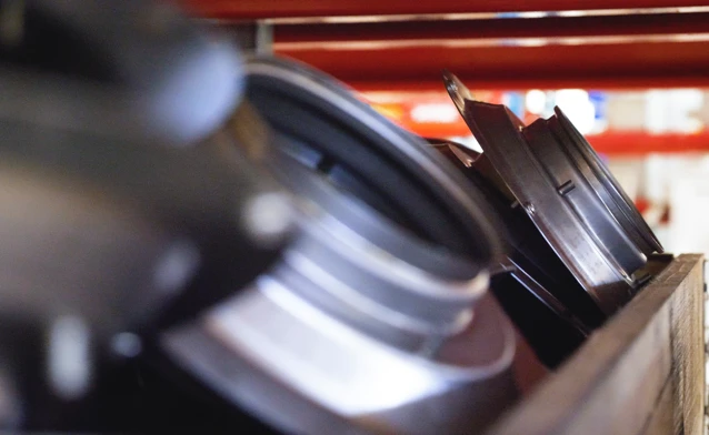 A close up of a camera on a wooden box.