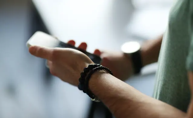 A close up of a person holding a cell phone.