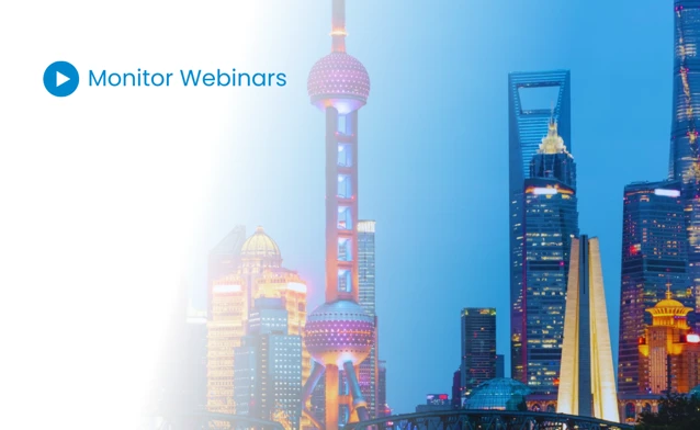 A picture of a city at night with the words monitor webinars.