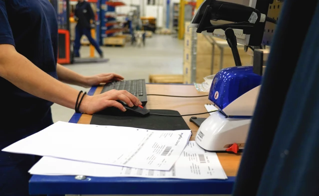 A man working on a computer in a factory.