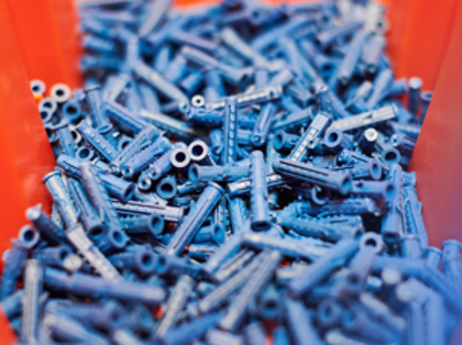 A bunch of blue screws in a plastic container.