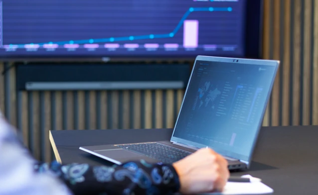 laptop on a table showing Monitor ERP Dashboard