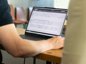 A person sitting at a table with a laptop.