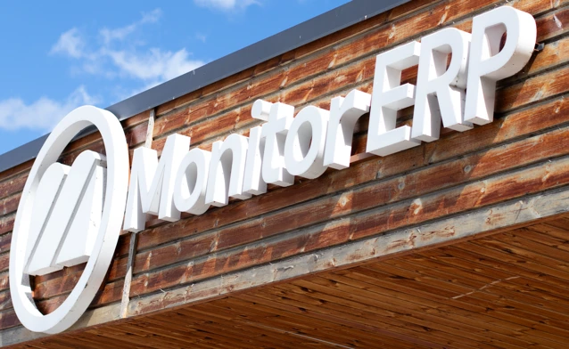 A sign of Monitor ERP on the side of a building.