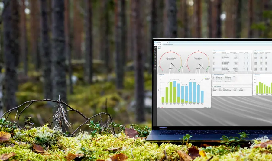 A laptop computer on top of a moss covered field displaying Monitor ERP sustainability function 